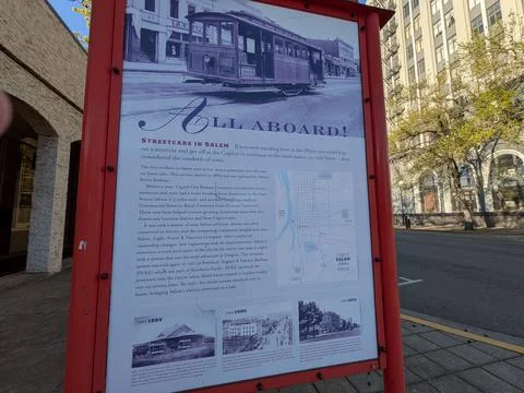 Educational “All Aboard” sign explains Salem’s streetcar history with maps Стоковые фото