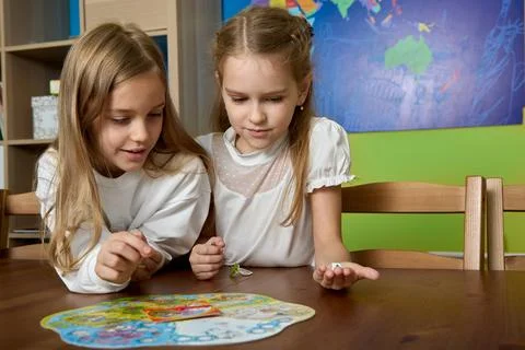 Educational children's game captivated two school girlfriends at recess Stock Photos