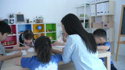 Educational concept. The teacher is teaching the child Take notes in the clas Stock Footage 131193028