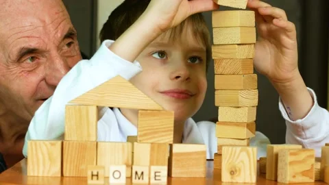 Educational joint board games theme. Caucasian pensioner and preschooler grandso Stock Footage 169954304