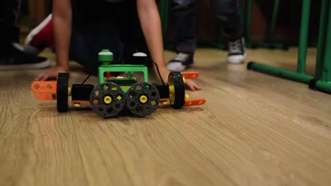 Educational robot moves across classroom floor while children watch during hands Vídeo Stock 341896188