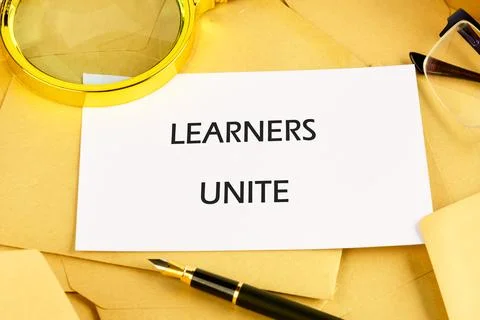 In an educational setup, various materials surround a card that emphasizes .. Stock Photos