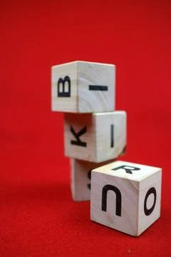 Educational stacking cube toy made of wood with numbers and letters Stock Photos