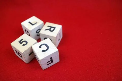 Educational stacking cube toy made of wood with numbers and letters Stock Photos