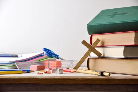 Educational supplies and religious objects on table with isolated background Stock Photos