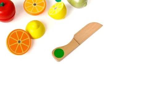 Educational toy set in the form of cut fruits and a wooden knife, isolated on Stock Photos