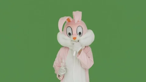 Eeaster rabbit got sick, takes medicine, tablets. Man in plush bunny suit holds Stock Footage 126696147
