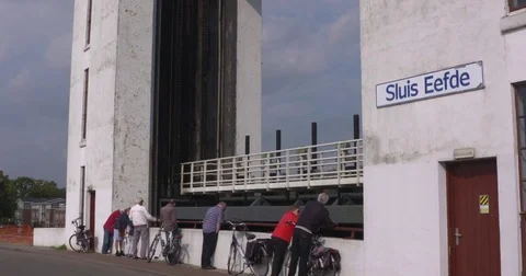 Eefde monumental lift lock complex - lift gate rises + spectators Stock Footage 81475843