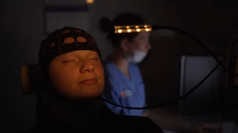 EEG examination of young man. Brain test in a dark office in hospital. Stock Footage 121624427
