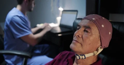 EEG Test on an Elderly Man at Hospital Laboratory Stock Footage 99771461