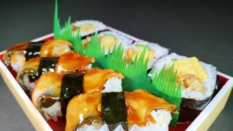 Eel Sushi in a plastic box, rotating Stock Footage 312126414