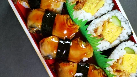 Eel Sushi in a plastic box, rotating Stock Footage 312126434