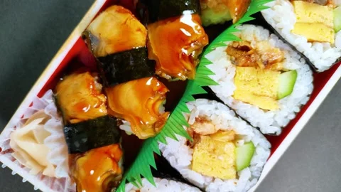 Eel Sushi in a plastic box, rotating Video stock 312533274