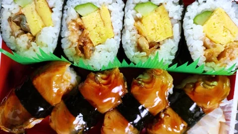 Eel Sushi in a plastic box, rotating Stock Footage 312975434