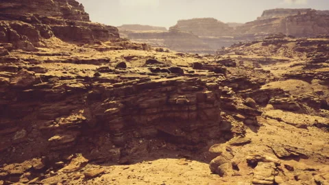 Eerie cliffs and deep canyons surrounded by shadows and distant misty mesas 库存影片 330072077