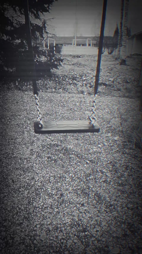 Eerie empty swing moving without nobody sitting on it. Video stock 289073835
