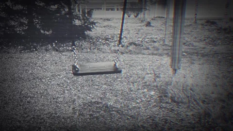 Eerie empty swing moving without nobody sitting on it. Video stock 289073842
