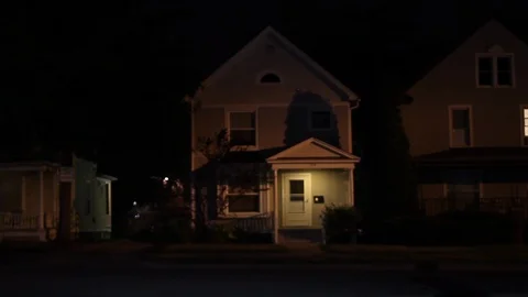 Eerie suburban house at night Stock Footage