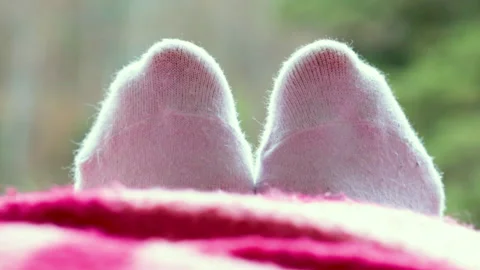 Eet in white socks mountain's hotel balcony Stock Footage 191038055
