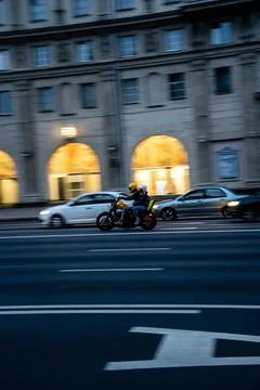 The effect of blurring in the movement of a motorcycle, in the evening city Stock Photos