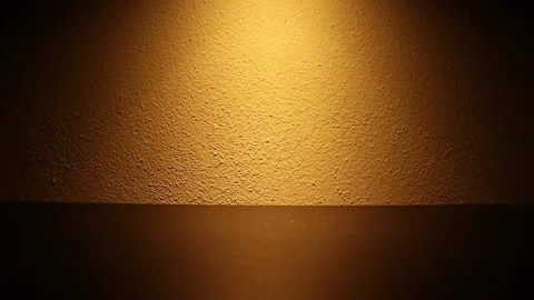 The effect of a dimmable light on a wall. The brightness of the light increases 動画素材 131707500