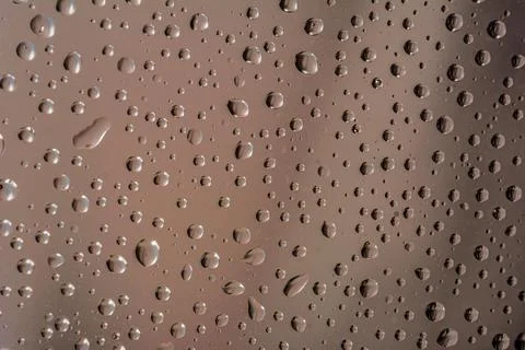 The effect of rain on a colored background. Stock Photos