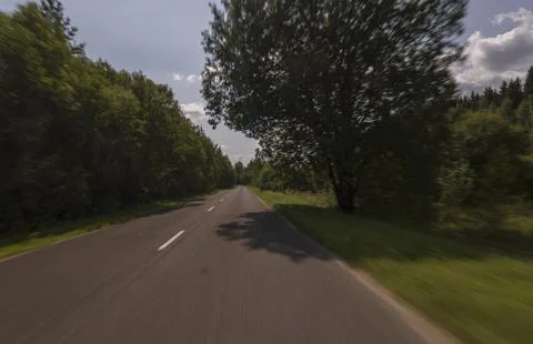 The effect of speed on the road and blurred objects. View of the road Stock Photos