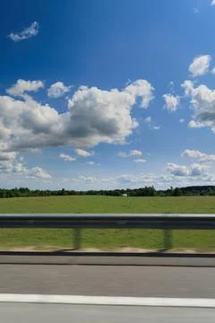 The effect of speed on the road and blurred objects. Roadside view and landscape 库存照片