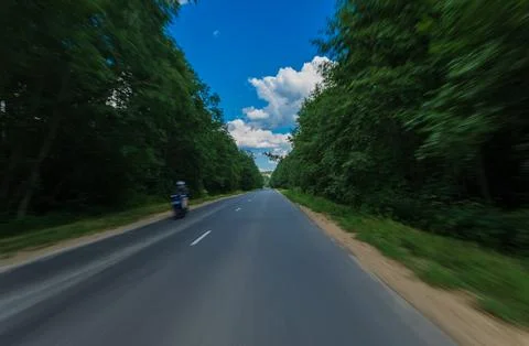 The effect of speed on the road. View of the road on a sunny summer day. Stock Photos