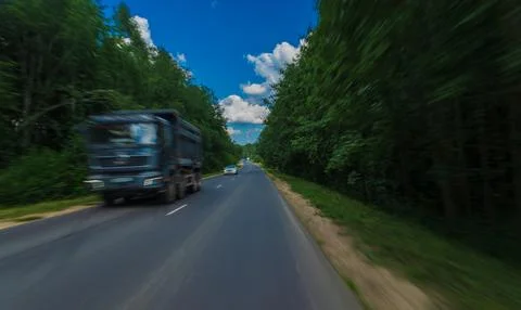 The effect of speed on the road. View of the road on a sunny summer day. Stock Photos
