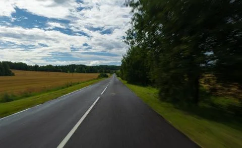 The effect of speed on the road. View of the road on a sunny summer day. 스톡 사진