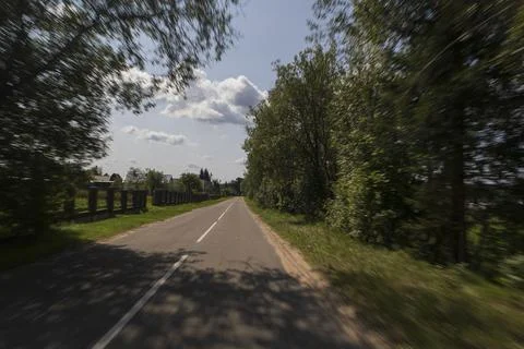 The effect of speed on the road. View of the road on a sunny summer day. Stock Photos