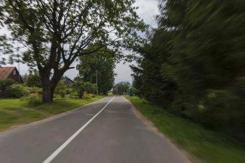 The effect of speed on the road. View of the road on a sunny summer day. Stock Photos