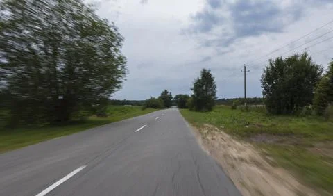 The effect of speed on the road. View of the road on a sunny summer day. Stock Photos