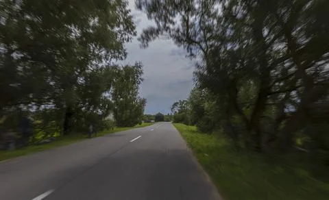 The effect of speed on the road. View of the road on a sunny summer day. Photos