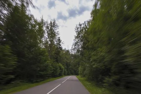 The effect of speed on the road. View of the road on a sunny summer day. Stock Photos
