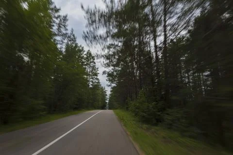 The effect of speed on the road. View of the road on a sunny summer day. Stock Photos