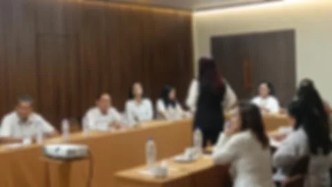 Effect view of A female speaker leads a business presentation, engaging with Stock Footage 340533838