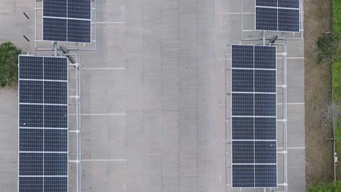 Effective photovoltaic solar panel installation over a parked black vehicle Stock Footage 299034686