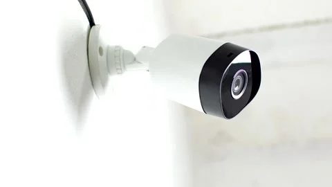 Effective Surveillance: CCTV security camera mounted on a white wall, ensur.. Video stock 260822291