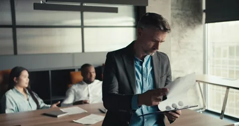 Effective work of a gray-haired middle-aged businessman in the office. Portrait Video stock 243454823