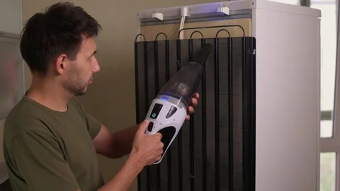 Effectively cleaning an refrigerator Unit using a vacuum is essential for Stock Footage 312647844