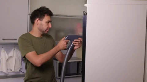 Effectively cleaning an refrigerator Unit using a vacuum is essential for Stock Footage 312647895