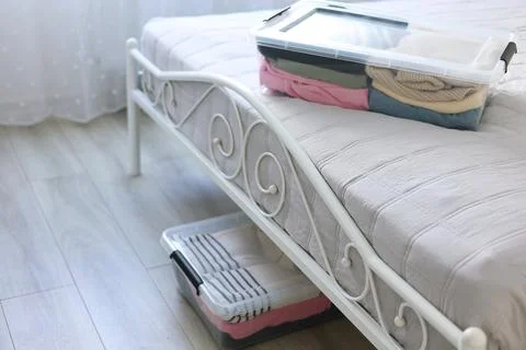 Effectively Organizing and Storing Clothes Under the Bed Using Clear Storage Stock Photos