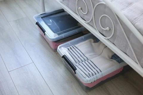 Effectively Organizing and Storing Clothes Under the Bed Using Clear Storage Stock Photos