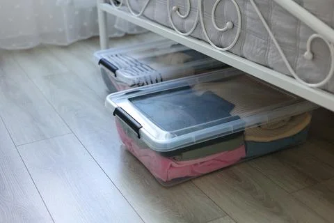 Effectively Organizing and Storing Clothes Under the Bed Using Clear Storage Stock Photos