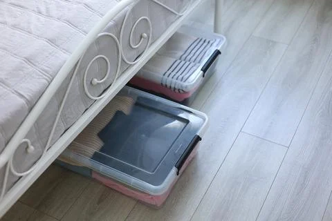 Effectively Organizing and Storing Clothes Under the Bed Using Clear Storage Stock Photos