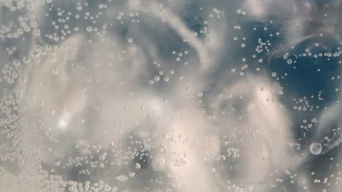 Effervescent drink with rising bubbles flows rightward in glass, creating Stock Footage 306166409