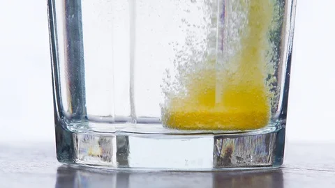 Effervescent orange pill white background Stock Footage 123802305
