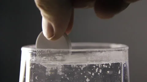 Effervescent soluble pill, water boils and squirts Stock Footage 64720087